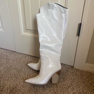 White pointed toe western knee-high boots with feaux snakeskin detailing.